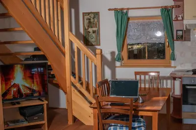 a dining room with a table with a laptop on it at house on the top of the hill in Mozirje