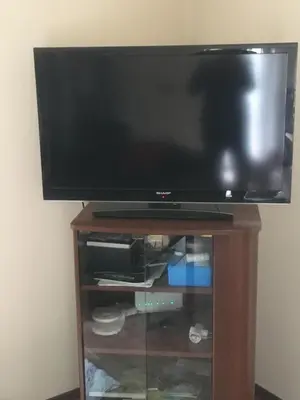 a flat screen tv sitting on top of a wooden stand at Apartmaji Velikonja in Ajdovščina