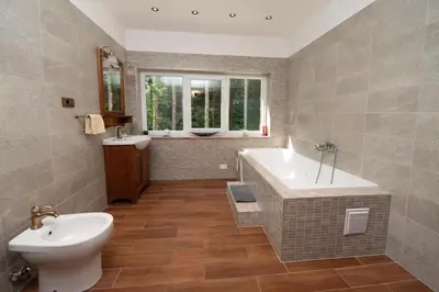 a bathroom with a tub and a sink and a toilet at Apartmaji Velikonja in Ajdovščina