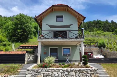 a house with a balcony on top of it at vakantiehuis Zidanica in Žužemberk