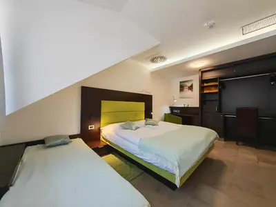 a bedroom with two beds and a staircase at Apartment Klara in Kranjska Gora