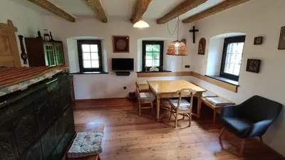a room with a table and a bed and a dining room at Country House Pri Lipet Žiri in Žiri