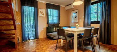 a dining room with a table and chairs at Apartma Julija Hiška 59 in Čatež ob Savi