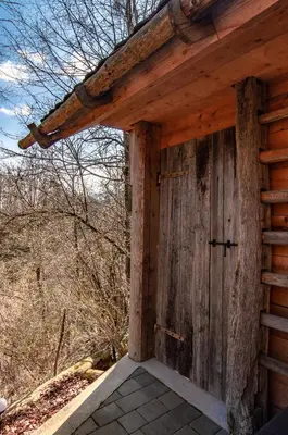 a wooden door on the side of a log cabin at Log House Natura in Radovljica