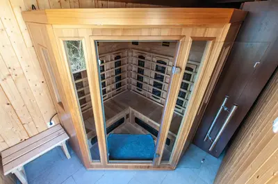 an inside view of a tiny house with a blue seat at Log House Natura in Radovljica