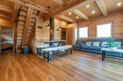 a log cabin living room with a couch and a table at Log House Natura in Radovljica