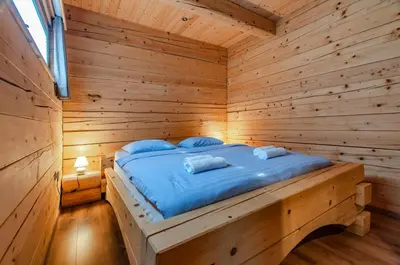a wooden room with a bed in a log cabin at Log House Natura in Radovljica