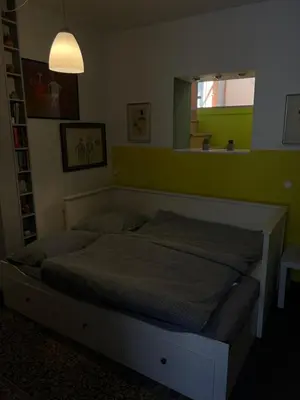 a bed in a bedroom with a green wall at Park in Ljubljana