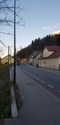 an empty street in a small town with houses at Park in Ljubljana