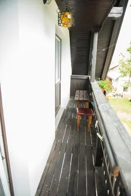 a porch with two benches and a window at Apartma Košnik PERUNIKA in Bohinj