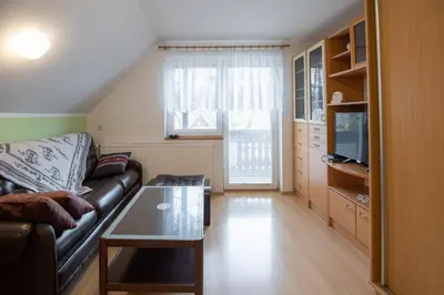 a living room with a couch and a table at Apartma Košnik PERUNIKA in Bohinj