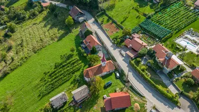 an aerial view of a house with a yard and a road at Zidanica Lackner in Črnomelj