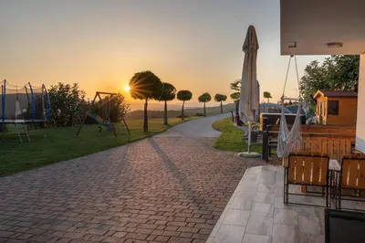 a pathway with a playground with the sunset in the background at Villa Four Stars ART-PE in Trebnje