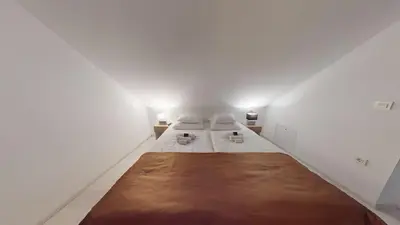 a bedroom with two beds in a white room at Villa Four Stars ART-PE in Trebnje