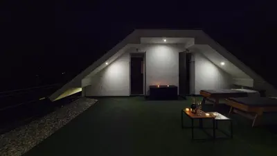 a dark room with a table and a stair case at Villa Four Stars ART-PE in Trebnje