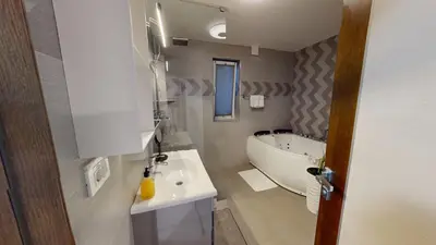 a bathroom with a tub and a sink and a bath tub at Villa Four Stars ART-PE in Trebnje