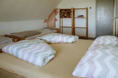 a room with three beds sitting on the floor at Dom na Slivnici in Cerknica