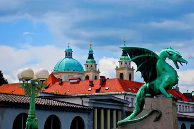 a green dragon statue in front of a building at Apartment Silver in Ljubljana