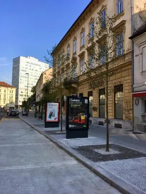 a street with two signs in front of a building at Apartment Gold in Ljubljana