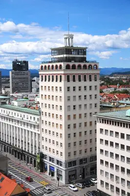 a large white building with a tower on top of it at Apartment Gold in Ljubljana