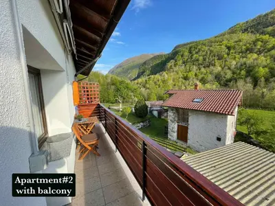 a balcony of a house with a view of a mountain at Hurja Apartments in Kobarid