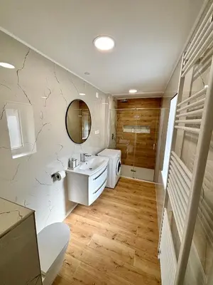 a bathroom with a white sink and a mirror at Hurja Apartments in Kobarid