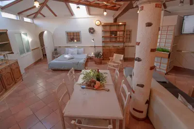 a living room with a table and chairs and a couch at Apartment Ana - Karst Cycling Paradise in Dutovlje