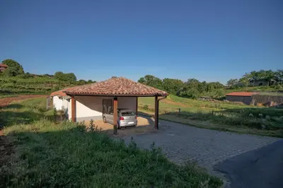 a car parked under a gazebo on a road at Apartment Ana - Karst Cycling Paradise in Dutovlje