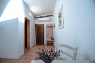 a room with a table and chairs and a hallway at Apartment Ana - Karst Cycling Paradise in Dutovlje