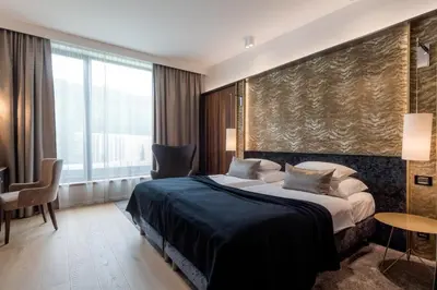 a hotel room with a bed and a large window at Hotel Nox in Ljubljana