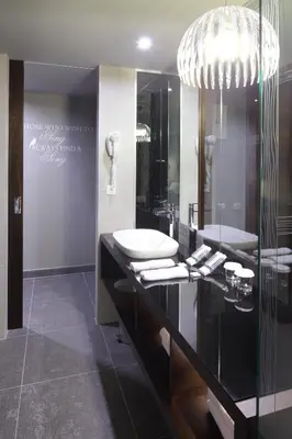 a bathroom with a sink and a mirror at Hotel Nox in Ljubljana