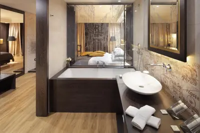 a bathroom with a bath tub and a sink at Hotel Nox in Ljubljana