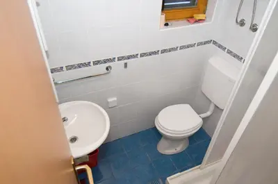a bathroom with a toilet and a sink at Apartmaji Snežinka Kope in Slovenj Gradec