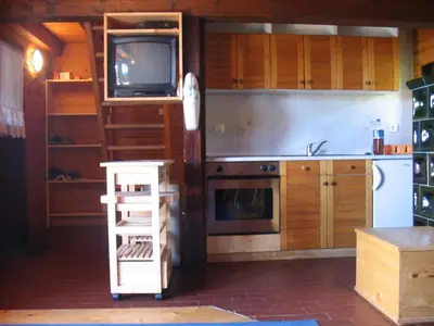 a kitchen with a tv and a ladder in it at Apartmaji Snežinka Kope in Slovenj Gradec