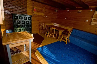 a dining room with wooden tables and chairs at Apartmaji Snežinka Kope in Slovenj Gradec