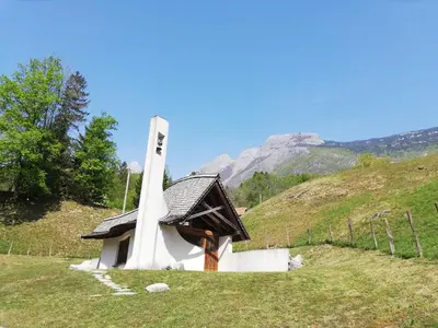 a small chapel on a hill in a field at Alpine Relax Bovec in Bovec
