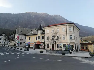 a street in a town with a mountain in the background at Alpine Relax Bovec in Bovec