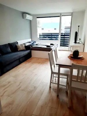 a living room with a table and a couch at Alpine Relax Bovec in Bovec