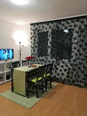 a dining room with a table and chairs and a wall at Apartmaji Sofia in Maribor