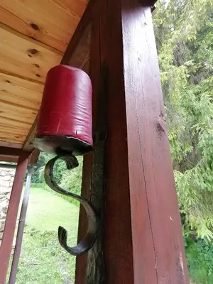 a red light on a porch with a snake hanging from it at Holiday house apartment Voukov mlin in Šmarje pri Jelšah