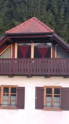 a balcony on top of a white building with windows at Holiday house apartment Voukov mlin in Šmarje pri Jelšah