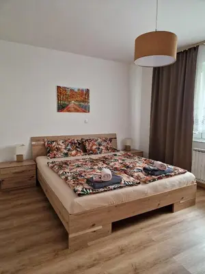 a bedroom with a large bed in a room at Apartma Kreda in Mojstrana
