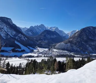 a view of a snowy mountain range with mountains at Apartma Kreda in Mojstrana