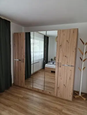 a room with large wooden doors and a bedroom at Apartma Kreda in Mojstrana