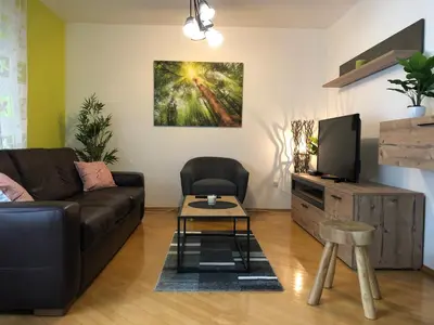 a living room with a couch and a tv at Apartma Kreda in Mojstrana