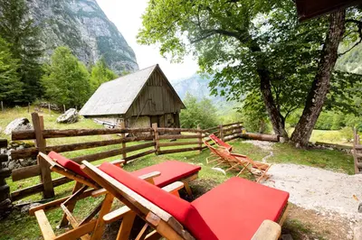 a group of chairs and a wooden barn at Alpine house Antonia in Trenta