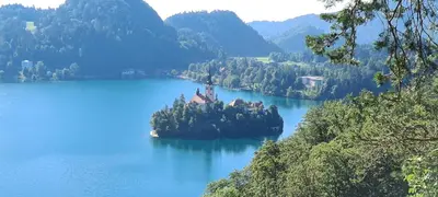 an island in the middle of a large body of water at Veldes B&B in Bled