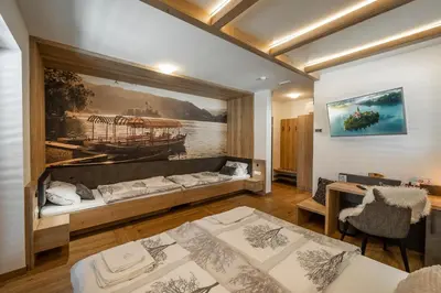 a room with two beds and a painting on the wall at Veldes B&B in Bled