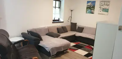 a living room with a couch and a table at APARTMAJI VITEZ apartma 2 in Bovec