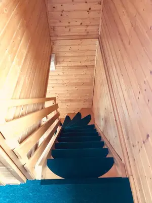 a room with wooden walls and stairs in a sauna at Holiday Cottage Krishtan in Podčetrtek